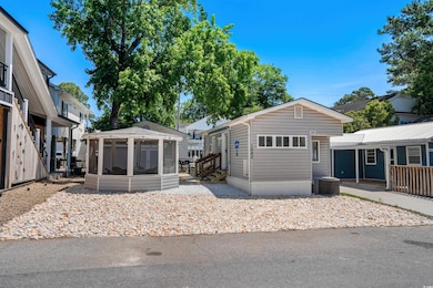 View of front of property with cooling unit, a sunroom, and entry steps