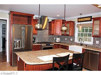 Kitchen. Beautiful back splash, stainless appliances stay! Gorgeous pendant lighting and recessed lights too.
