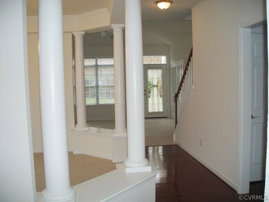 View from the foyer of the spacious dining room to the left and the living room ahead.