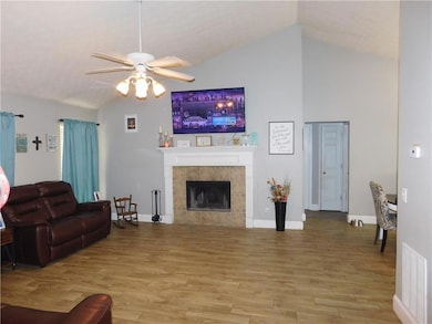 Living room featuring vaulted ceiling, visible ven