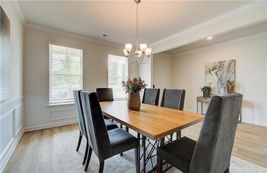 Dining room with visible vents, crown molding, wai
