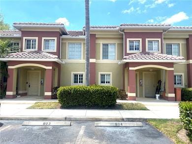 View of front of property with a tiled roof, stucc