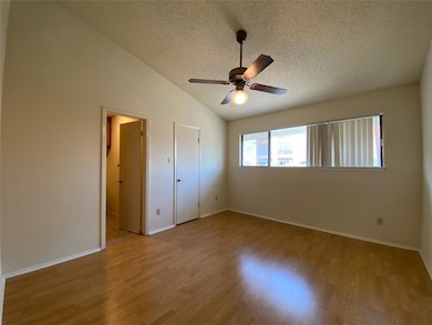 Unfurnished bedroom featuring lofted ceiling, bas