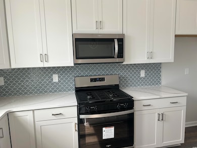 Kitchen featuring light countertops, decorative ba