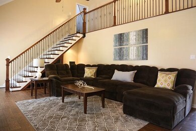 The living room features stunning hardwood floorin