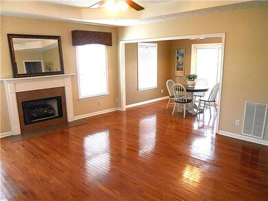 Gorgeous hardwood floors, trey ceiling & gas fireplace are features in the living room.