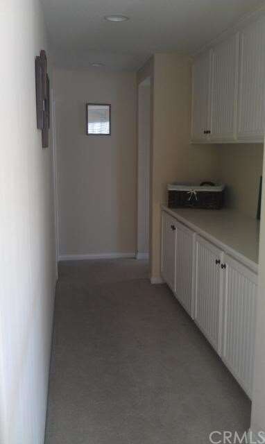 Hallway with storage leading to three upstairs bed