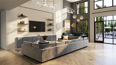 Living room featuring a high ceiling, plenty of natural light, an inviting chandelier, and light hardwood / wood-style floors