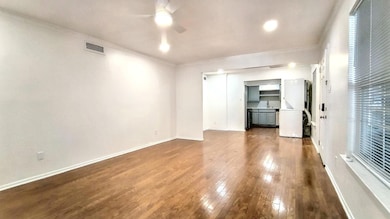 Unfurnished living room featuring wood-type floori