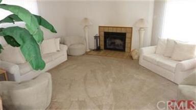 Living room with luxurious carpet and cozy firepla