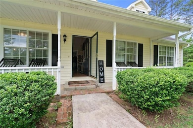 View of exterior entry with covered porch