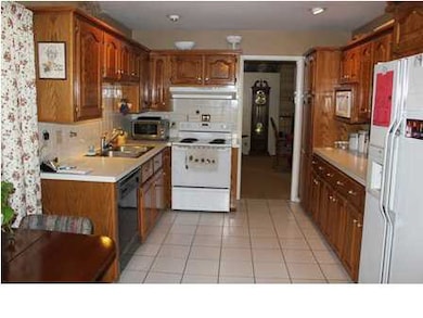 Kitchen with lots of oak cabinets and all applianc