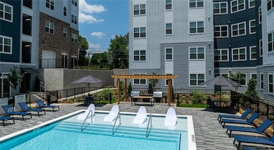 Community pool with a pergola and a patio area