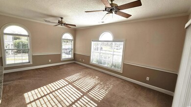 Spare room featuring ceiling fan, a textured ceili