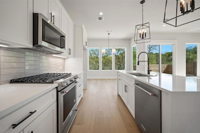 Kitchen featuring light wood-style flooring, a si