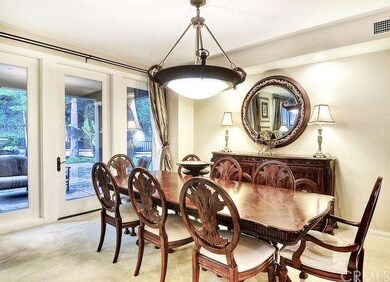 Accented by a beautiful light fixture, the formal 