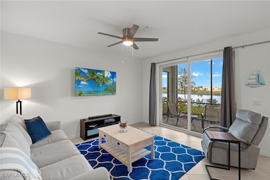 Living room with light tile patterned floors and c