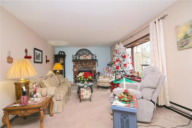Formal living area with stone fireplace