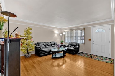 Living room featuring crown molding and hardwood /