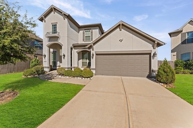 Stucco exterior with a well-maintained front yard featuring lush green grass and neatly trimmed shrubs, with a paved driveway leading to the entrance.