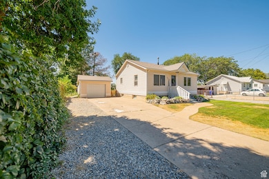 View of front of property featuring an outdoor structure and driveway