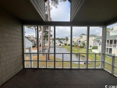 Unfurnished sunroom featuring a water view