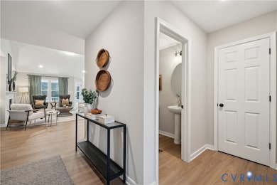 Corridor with light wood-style flooring and recessed lighting