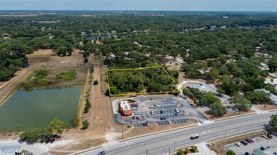 Aerial view of property's location with a nearby body of water and property boundaries highlighted
