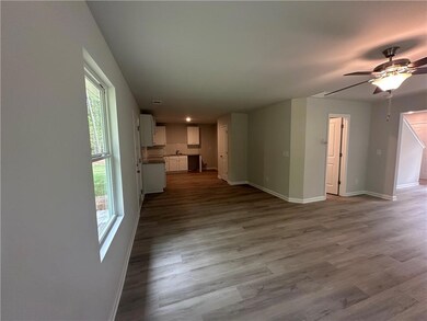 Unfurnished living room with baseboards, ceiling f