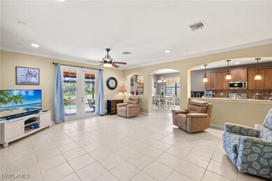 Great room featuring crown molding, arched walkway