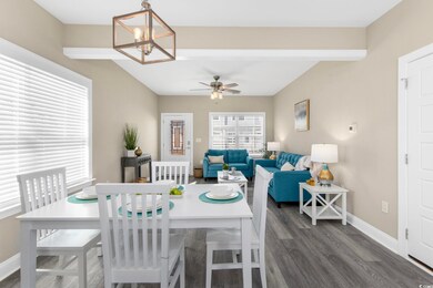 Dining space with a chandelier, ceiling fan, dark 