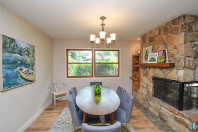 New LVP Flooring, pen to adjoining FP & Kitchen with large east facing windows.