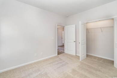 Unfurnished bedroom featuring light colored carpet