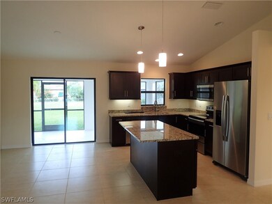 DINING ROOM AND KITCHEN WITH ISLAND CABINET AT 531 SE 32nd TER
