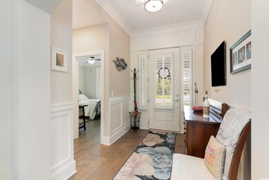 Entrance foyer featuring ornamental molding, dark 