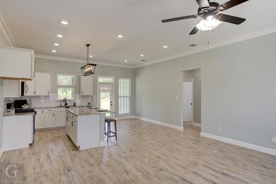 Kitchen with white cabinetry, light hardwood / woo