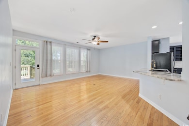 Unfurnished living room with a ceiling fan, plenty