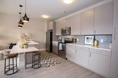 Kitchen with light hardwood / wood-style floors, s