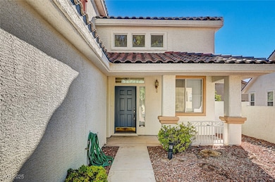 Entrance to property with a tile roof, stucco siding, and a porch