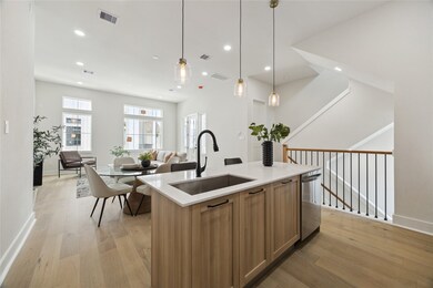 Modern open-concept kitchen, dining, and living ar