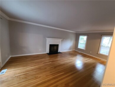 Unfurnished living room featuring ornamental moldi