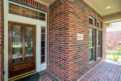 The covered front porch with recessed lighting is waiting for someone to come and enjoy!