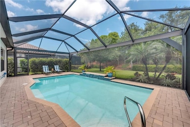 Outdoor pool featuring a patio area and glass enclosure