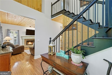 Beautiful two story foyer featuring hardwoods and a view to the living room.