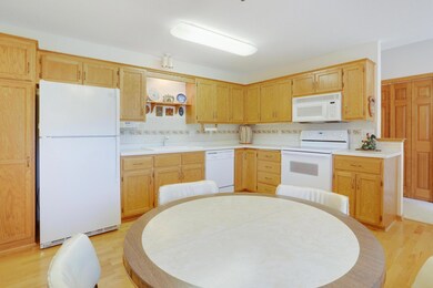 Bright and spacious eat-in kitchen with plentiful cabinets.