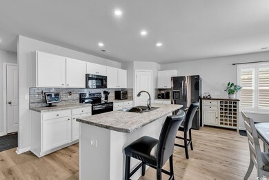 Kitchen with tasteful backsplash, a kitchen breakf