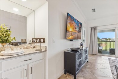 Bathroom featuring crown molding, tile flooring, and vanity