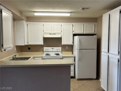 Kitchen featuring white appliances, under cabinet