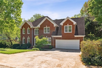 View of front of home featuring brick siding, a ga
