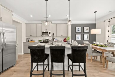 Kitchen featuring light stone counters, stainless 